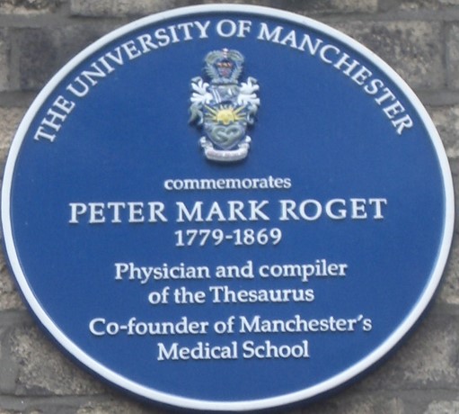 blue round plaque attached to old brick wall stating “The University of Manchester commemorates Peter Mark Roget (1779-1869), Physician and compiler of the Thesaurus, Co-founder of Manchester’s Medical School.”