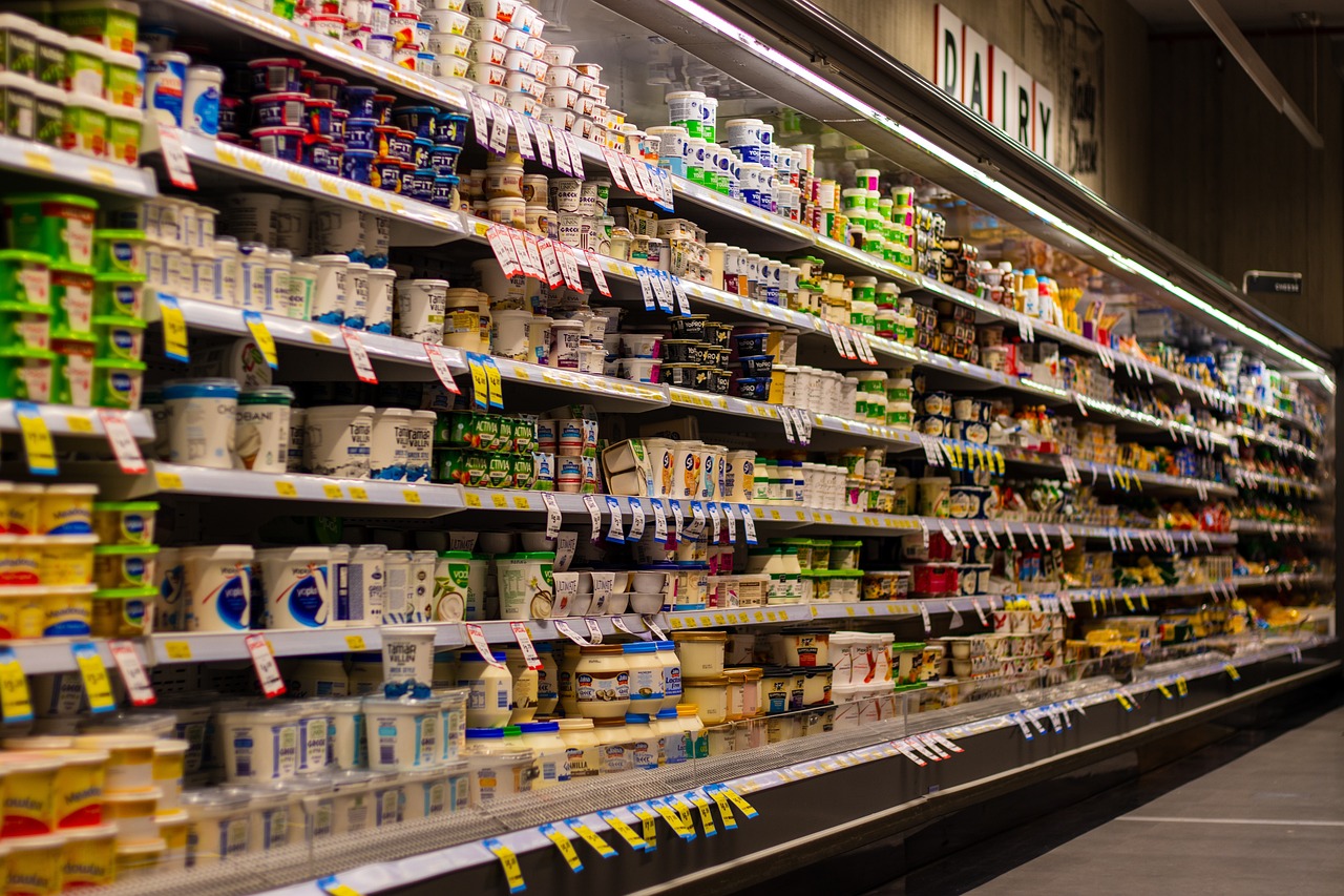 Long shelf of dairy products in grocery store