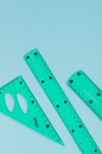 Translucent turquoise rulers on a light blue background.