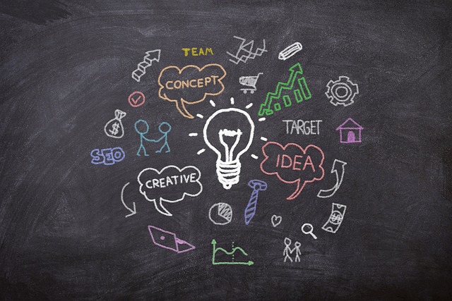 A chalkboard shows a large white lightbulb drawn in the center of other drawings and words. Words include: idea, creative, SEO, team, target.