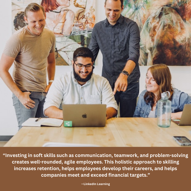 Four smiling people looking at laptop. Text under photo reads: “Investing in soft skills such as communication, teamwork, and problem-solving creates well-rounded, agile employees. This holistic approach to skilling increases retention, helps employees develop their careers, and helps companies meet and exceed financial targets.” —LinkedIn Learning "