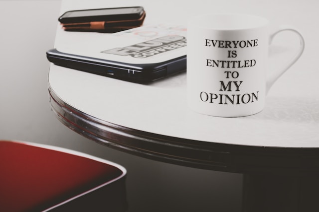 White mug with text on it that reads, "Everyone is entitled to MY OPINION."