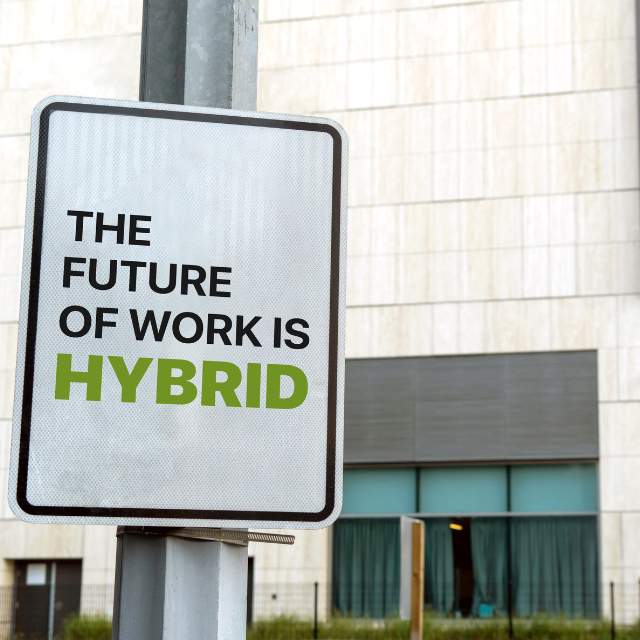 Street sign with "The Future of Work is Hybrid" on it.